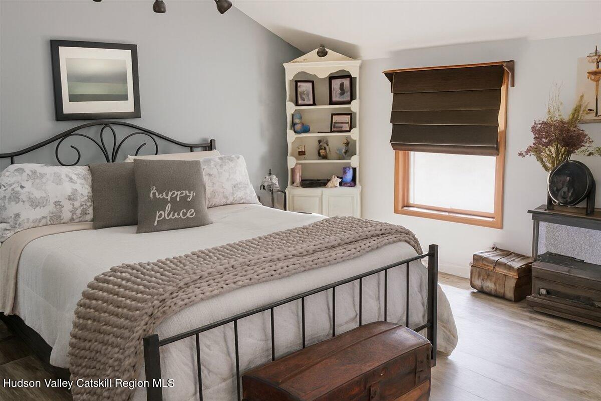 266 Scheller Park Road West Coxsackie, NY 12192 - Photo 23 of 26 a bedroom with a bed a dresser and a window