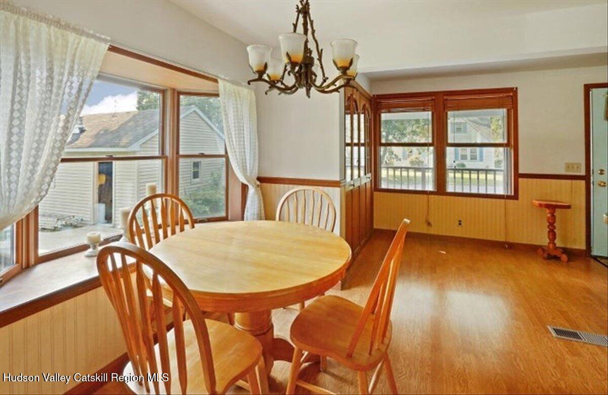 266 Scheller Park Road West Coxsackie, NY 12192 - Photo 4 of 26 a dining room with furniture a chandelier and wooden floor