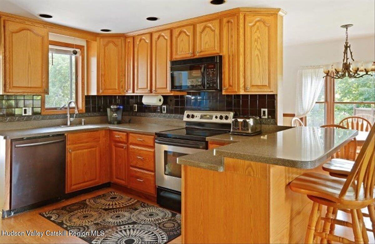 266 Scheller Park Road West Coxsackie, NY 12192 - Photo 7 of 26 a kitchen with a sink a stove and cabinets