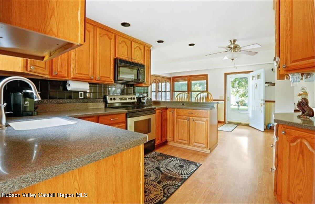 266 Scheller Park Road West Coxsackie, NY 12192 - Photo 8 of 26 a kitchen with stainless steel appliances granite countertop a stove a sink and a refrigerator