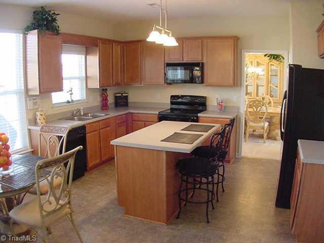 4706 Ridge Fall Road Greensboro, NC 27410 - Photo 2 of 9 Other. Beautiful Large Eat-in Kitchen has Black Appliances, Large Center Island, Smooth-top Range/Oven, Microwave and Nice Pantry