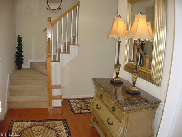4706 Ridge Fall Road Greensboro, NC 27410 - Photo 6 of 9 Other. Foyer Entry and Hall has Hardwood Floors and Oak Handrail on Staircase