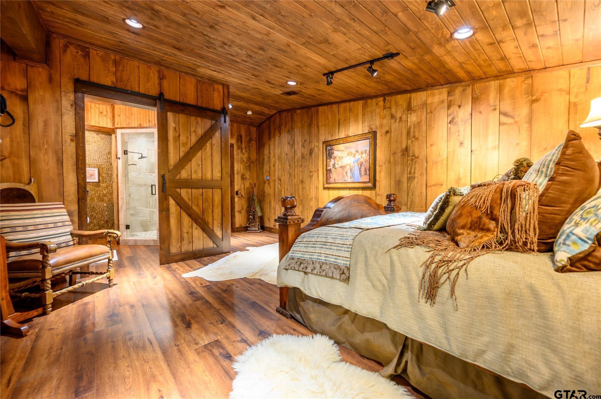 1450 County Road Sumner, TX 75486 - Photo 16 of 35 a spacious bedroom with a bed and a large window