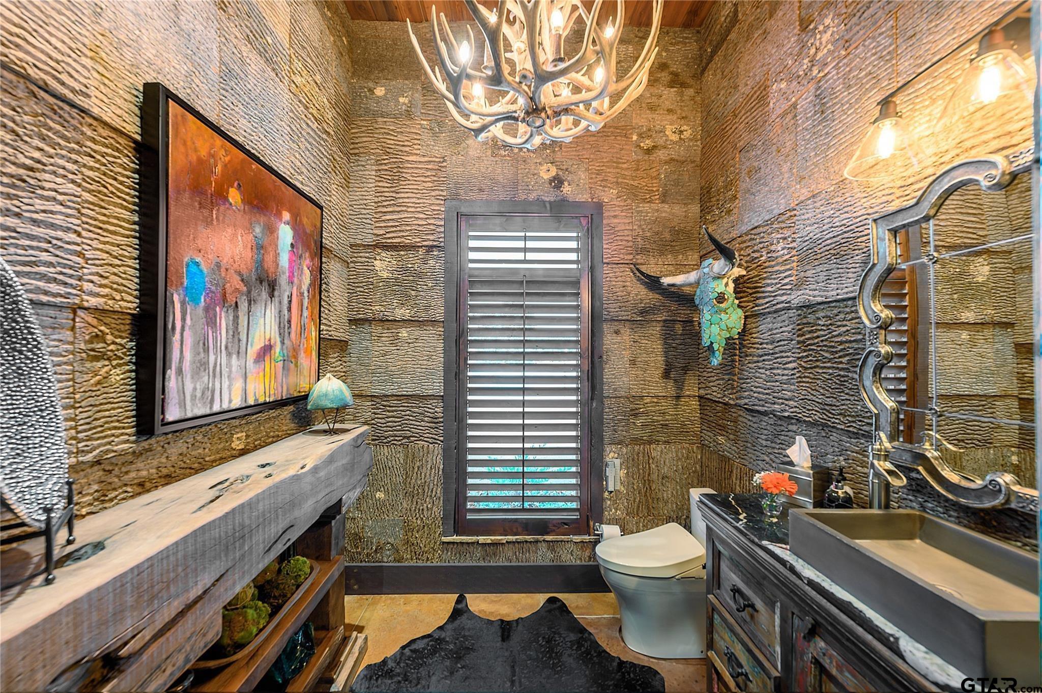 1450 County Road Sumner, TX 75486 - Photo 23 of 35 a bathroom with a toilet sink and mirror