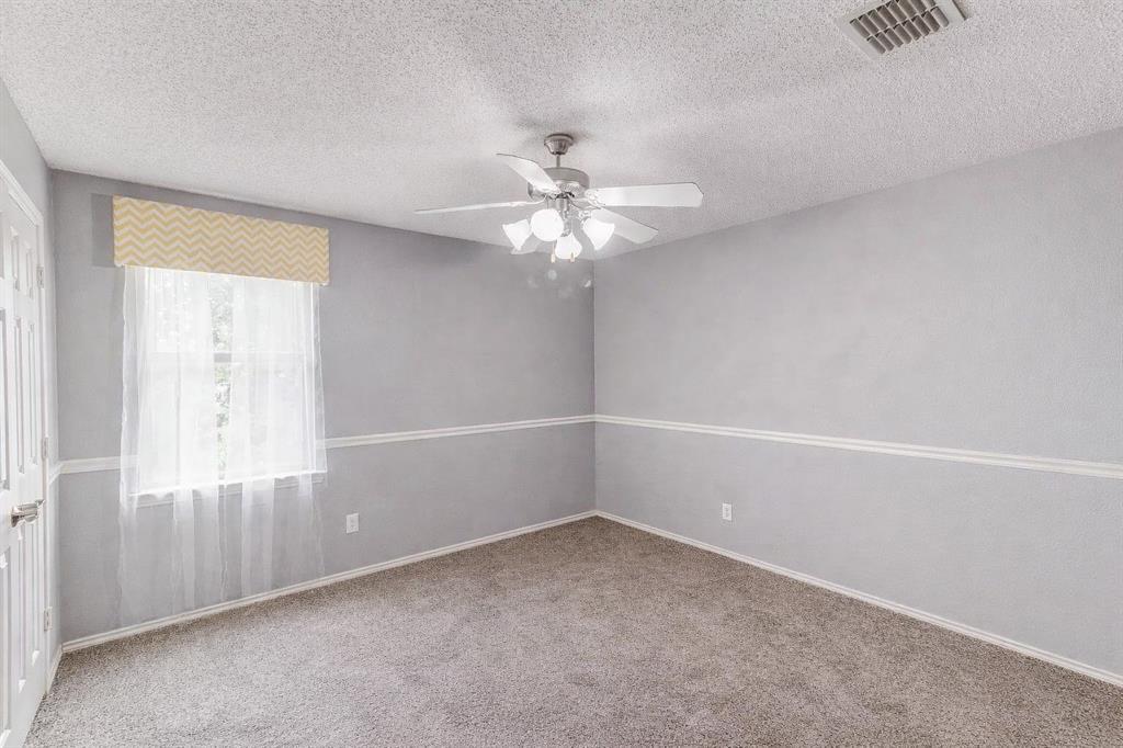 3601 McClintick Road McKinney, TX 75070 - Photo 21 of 24 an empty room with a window and a chandelier fan