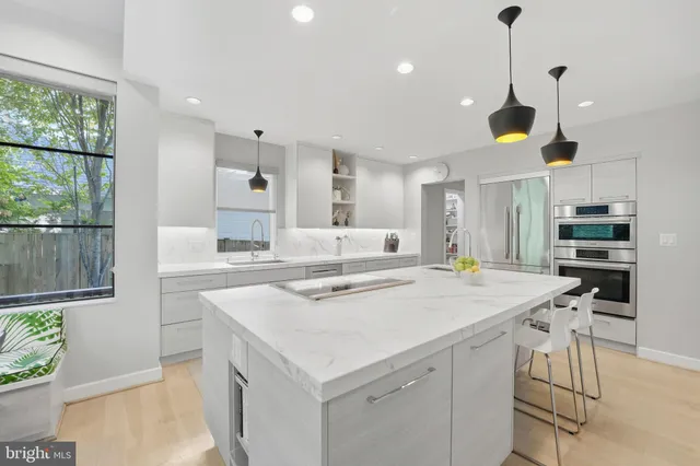 a view of a hallway with wooden floor and a potted plant