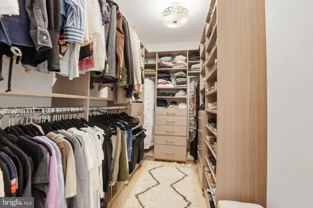 a bedroom with a bed and a window with chair