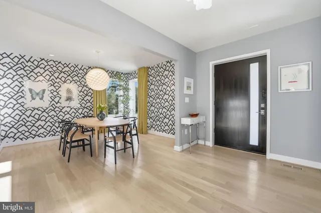 a view of a dining room with furniture and a chandelier