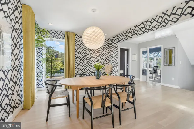 a view of a dining room with furniture and chandelier