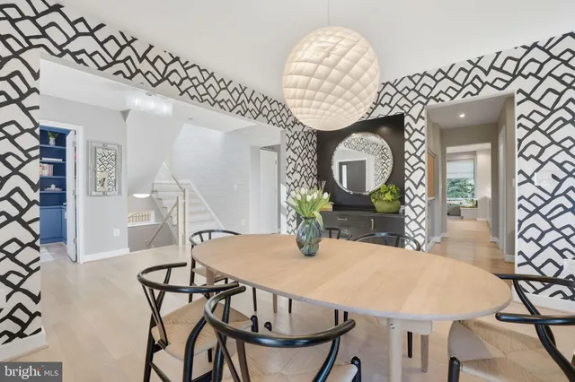 a living room with furniture a bookshelf and a large window