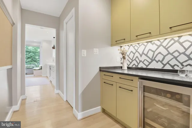 a view of a hallway with wooden shelves
