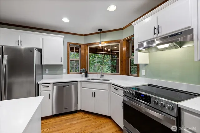 a kitchen with a stove a sink and a refrigerator