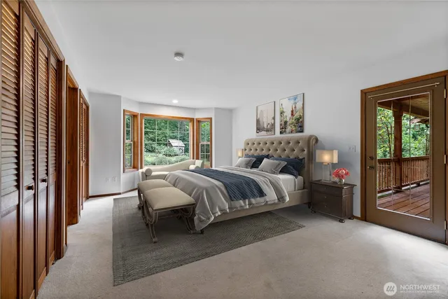 a spacious bedroom with a bed and a large window