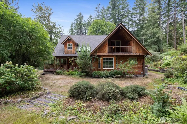 a front view of a house with yard and green space
