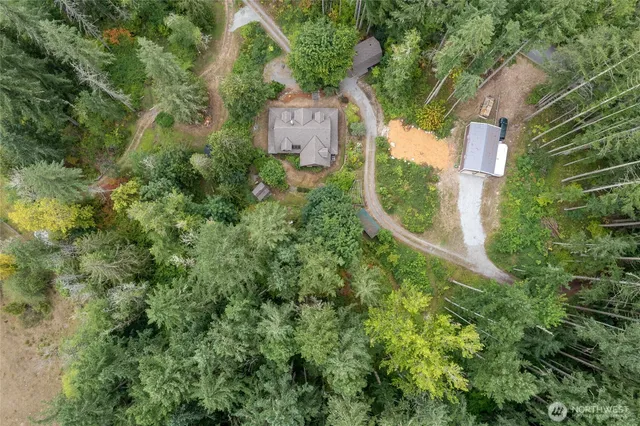an aerial view of a house with a yard