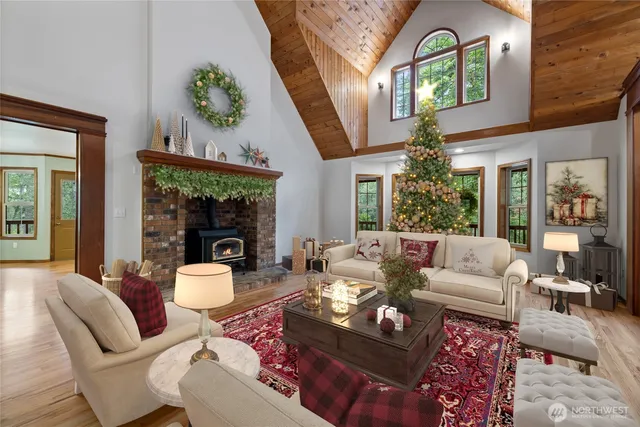 a living room with furniture fireplace and a large window