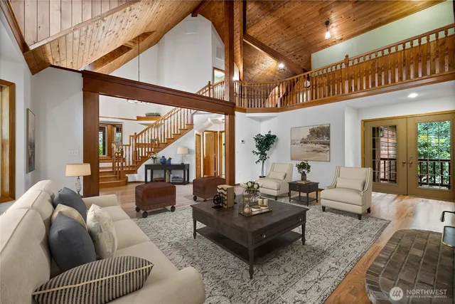 a living room with furniture a rug and a large window