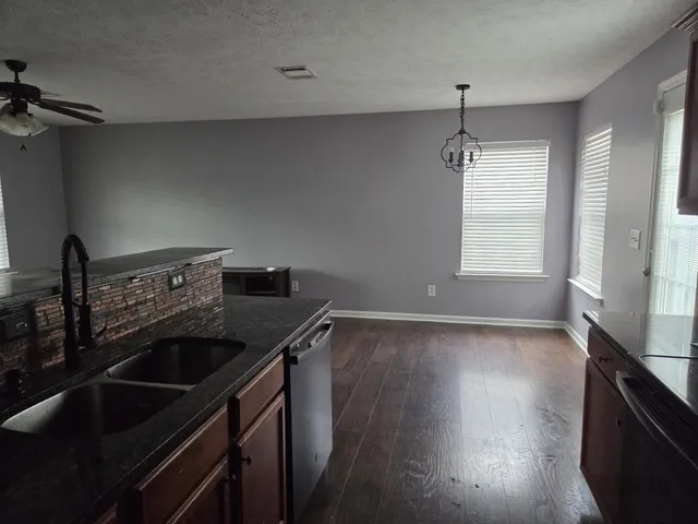 a kitchen that has a sink and a stove