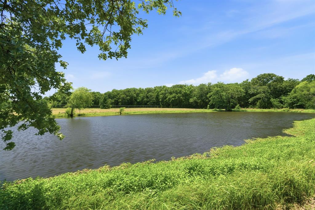 321 Cr 211 Road Gainesville, TX 76240 - Photo 24 of 40 Pond is situated between the home and barns.