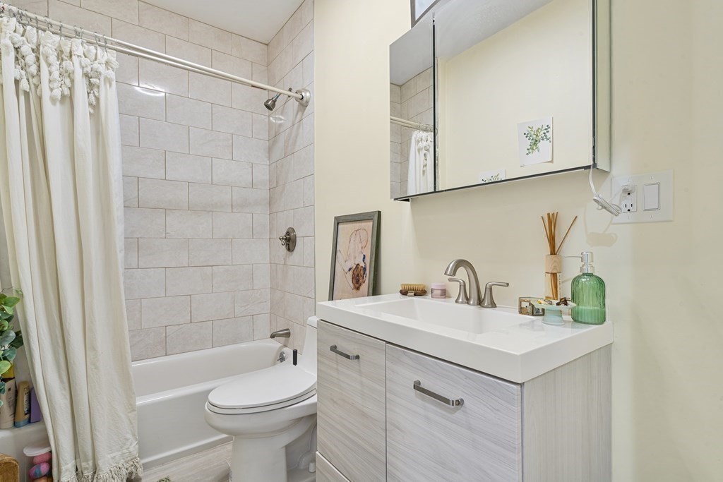 8 Loring Place, Unit 8 Boston, MA 02136 - Photo 12 of 23 a bathroom with a sink a toilet and shower