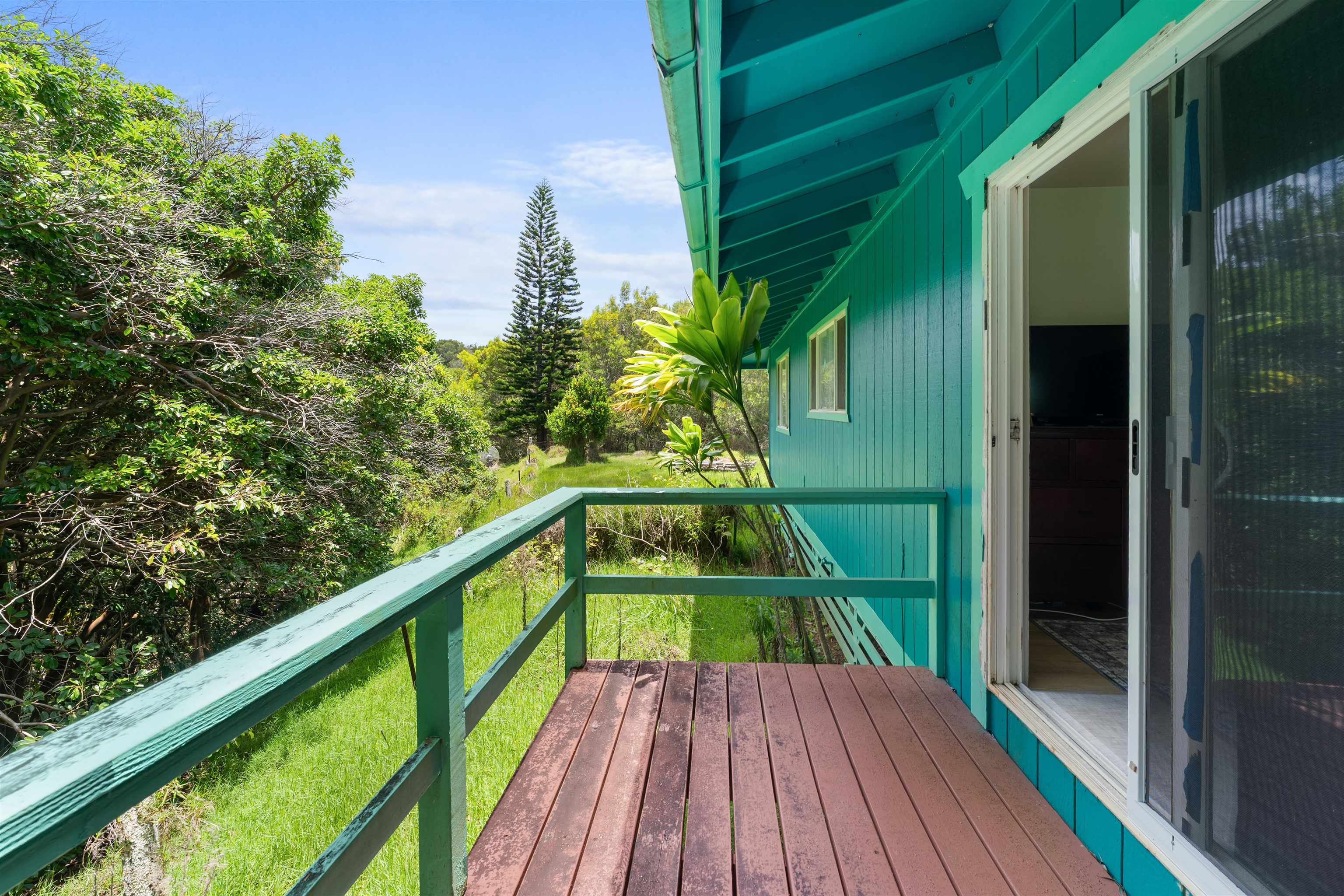 2115 Kaupakalua Road Haiku, HI 96708 - Photo 12 of 26 a view of balcony with wooden floor and outdoor space