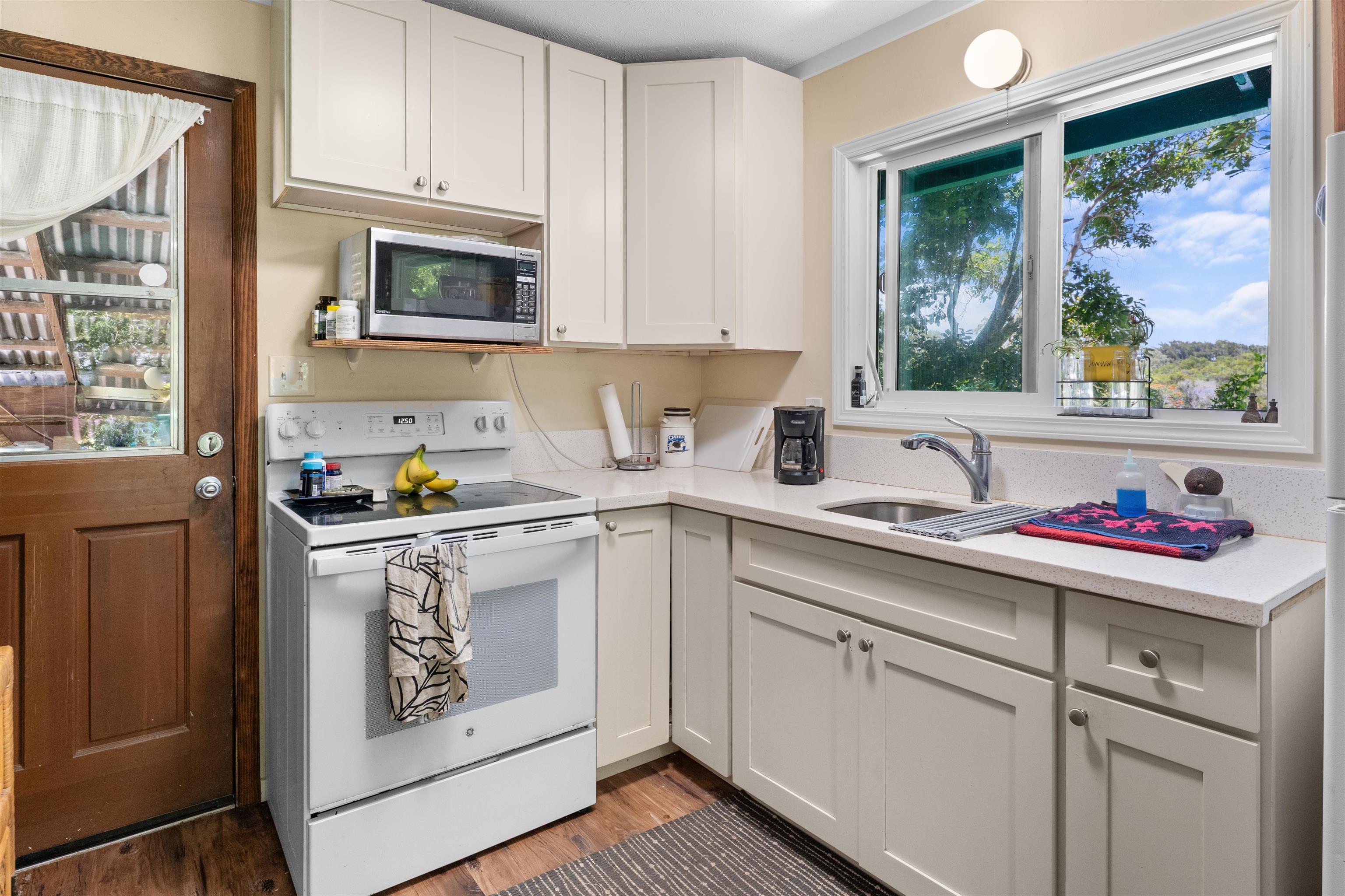 2115 Kaupakalua Road Haiku, HI 96708 - Photo 15 of 26 a kitchen with a sink cabinets and window