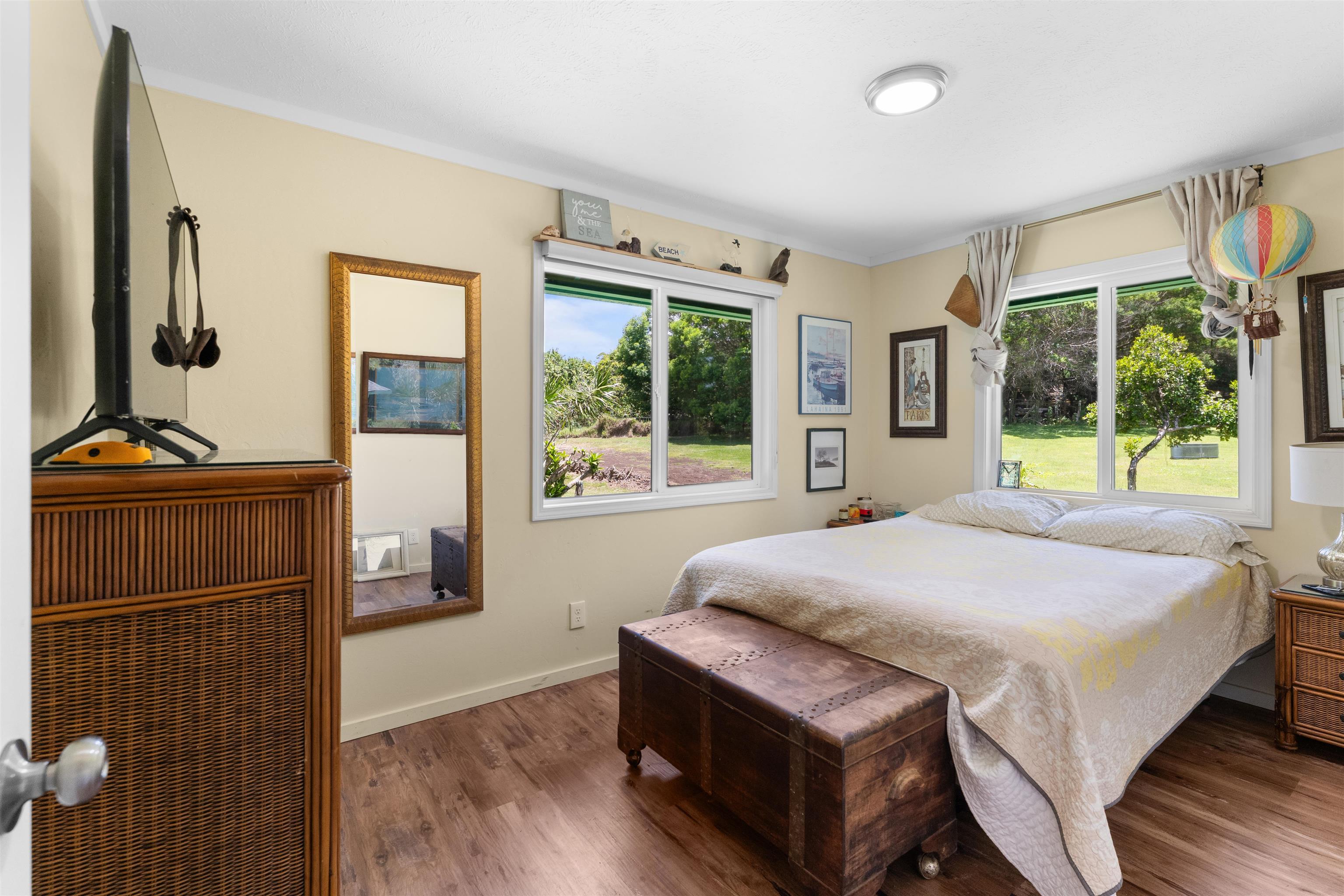 2115 Kaupakalua Road Haiku, HI 96708 - Photo 19 of 26 a bed sitting in a bedroom next to a window