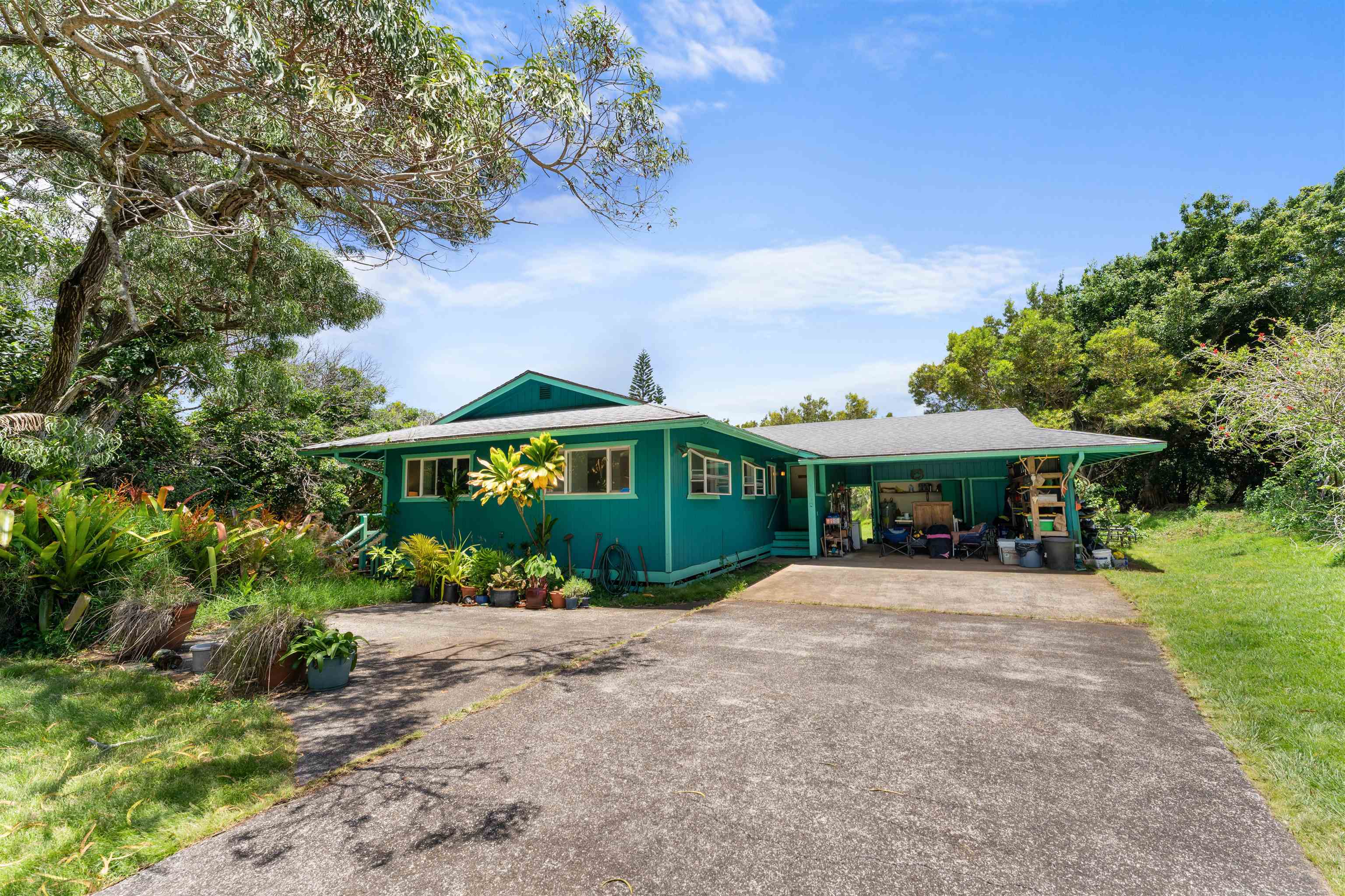 2115 Kaupakalua Road Haiku, HI 96708 - Photo 2 of 26 a view of a house with a yard and potted plants