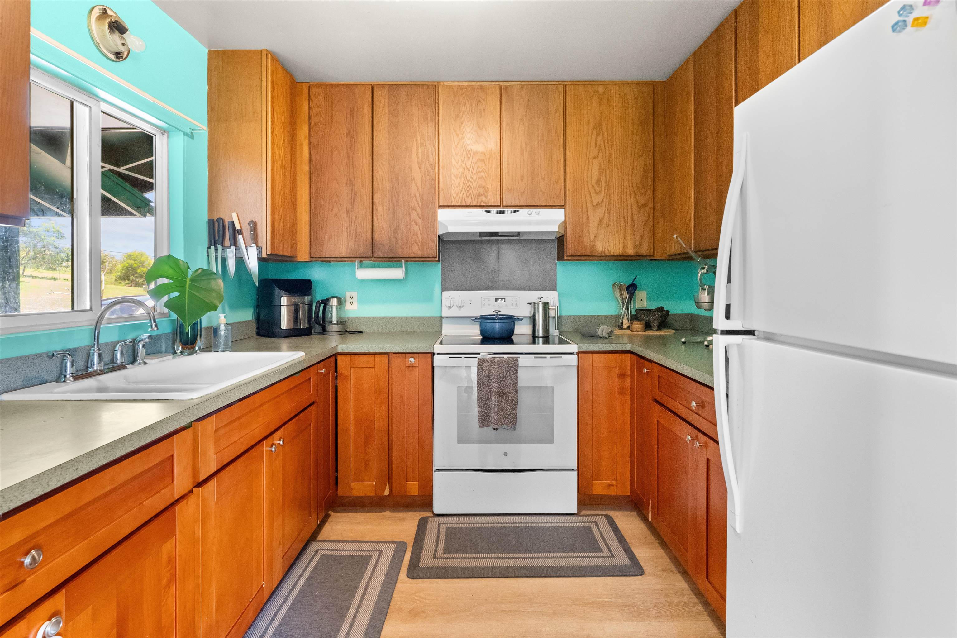 2115 Kaupakalua Road Haiku, HI 96708 - Photo 4 of 26 a kitchen with stainless steel appliances granite countertop a refrigerator a sink and a stove