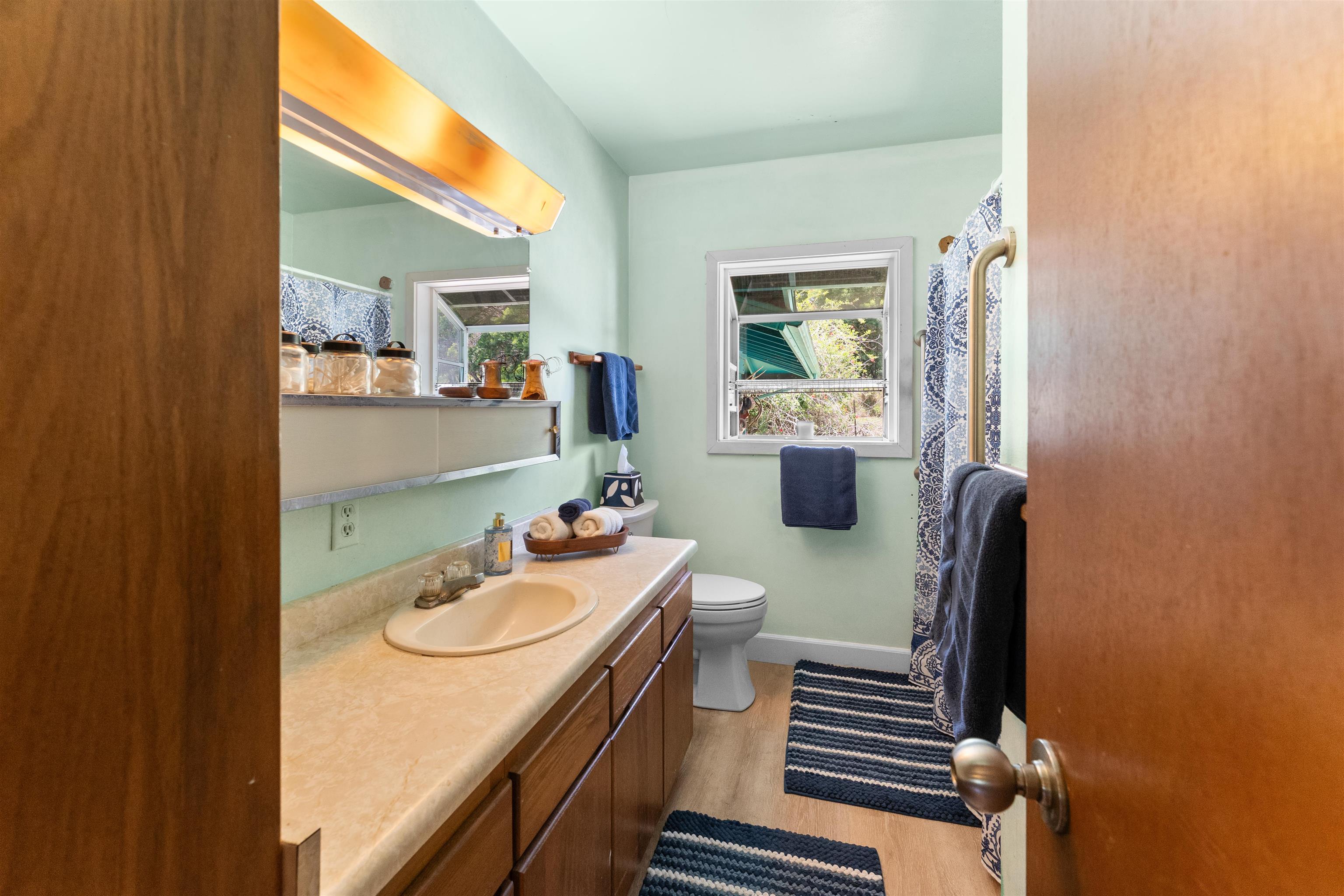 2115 Kaupakalua Road Haiku, HI 96708 - Photo 8 of 26 a bathroom with a sink a toilet and mirror
