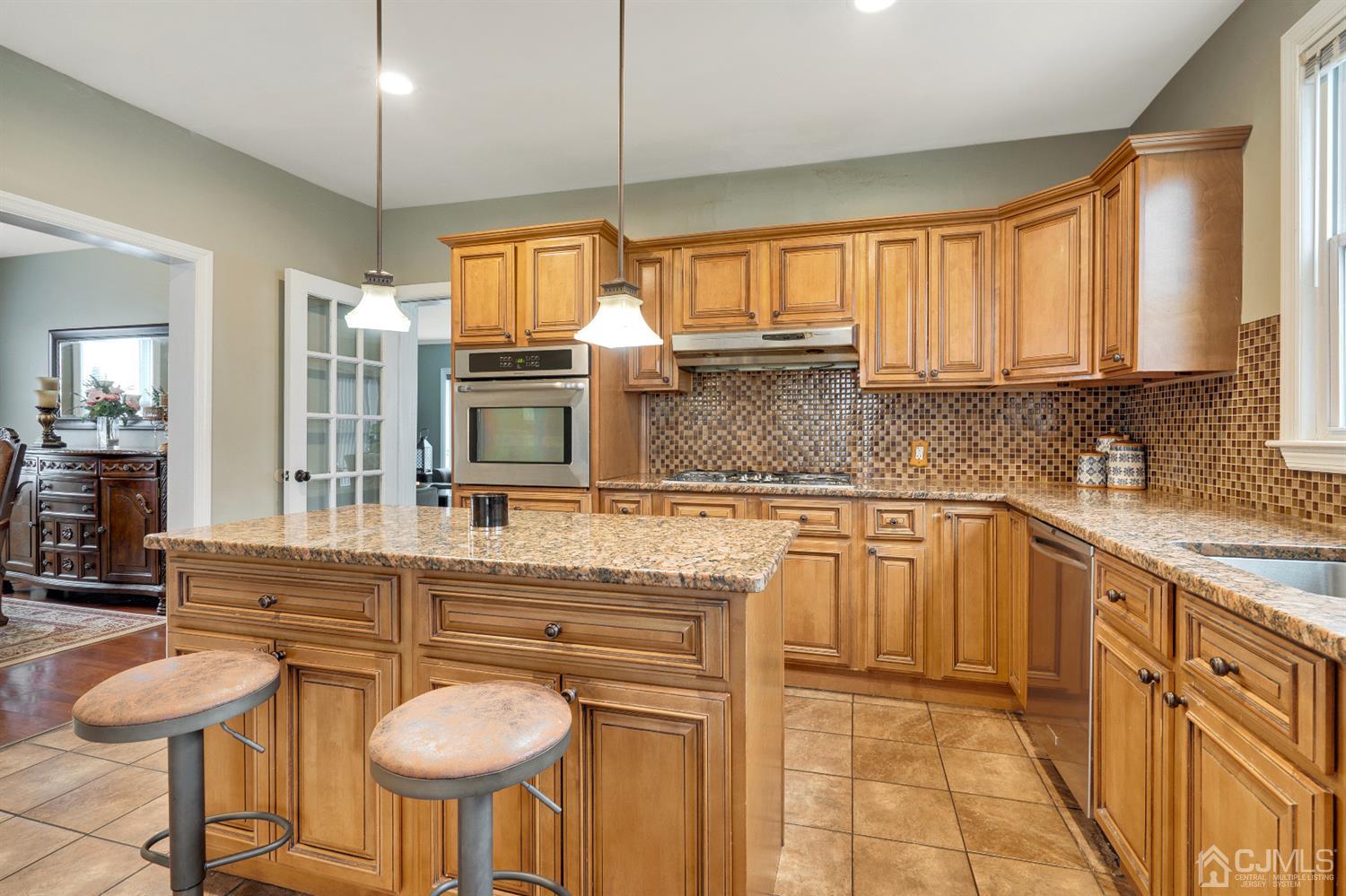 605 Beers Street Hazlet, NJ 07730 - Photo 12 of 32 a kitchen with stainless steel appliances granite countertop a sink and a refrigerator