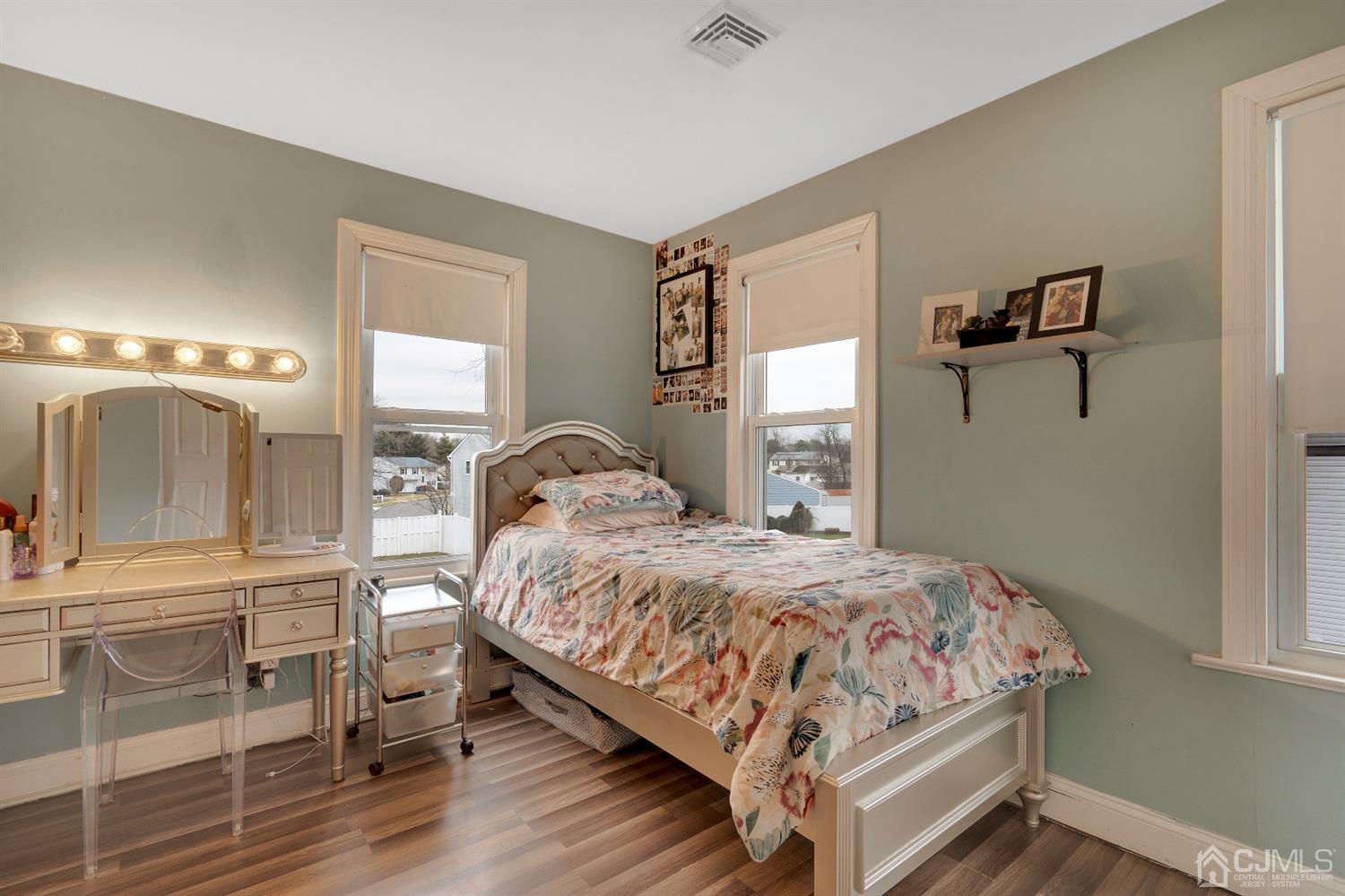 605 Beers Street Hazlet, NJ 07730 - Photo 19 of 32 a bedroom with a bed and a mirror