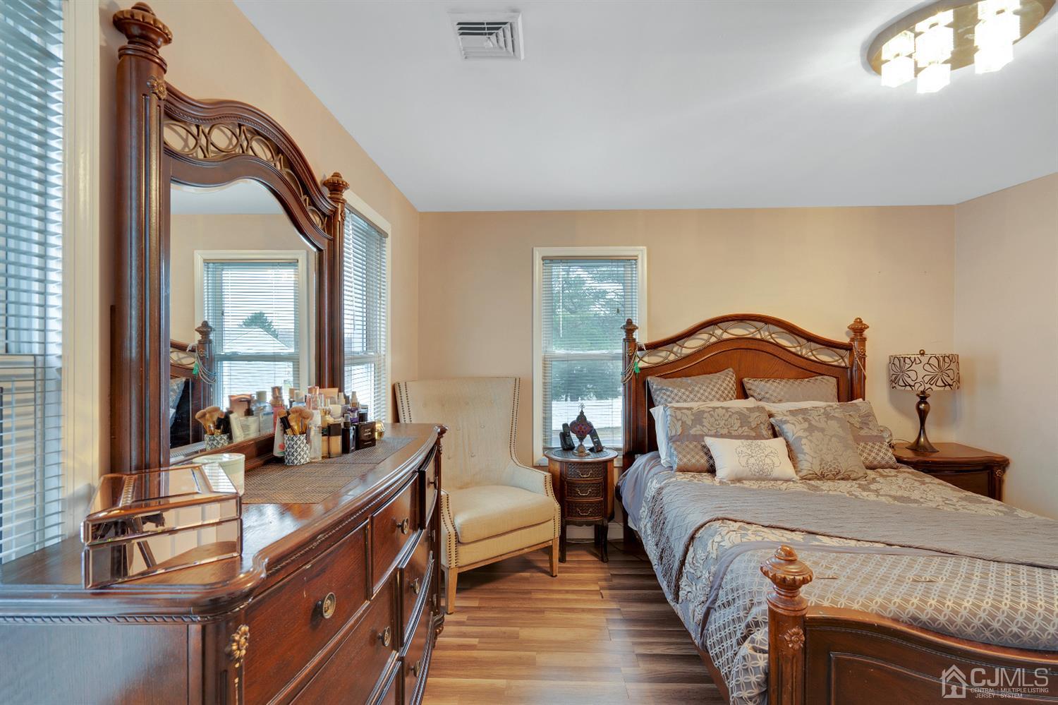 605 Beers Street Hazlet, NJ 07730 - Photo 21 of 32 a bedroom with bed a mirror and a window