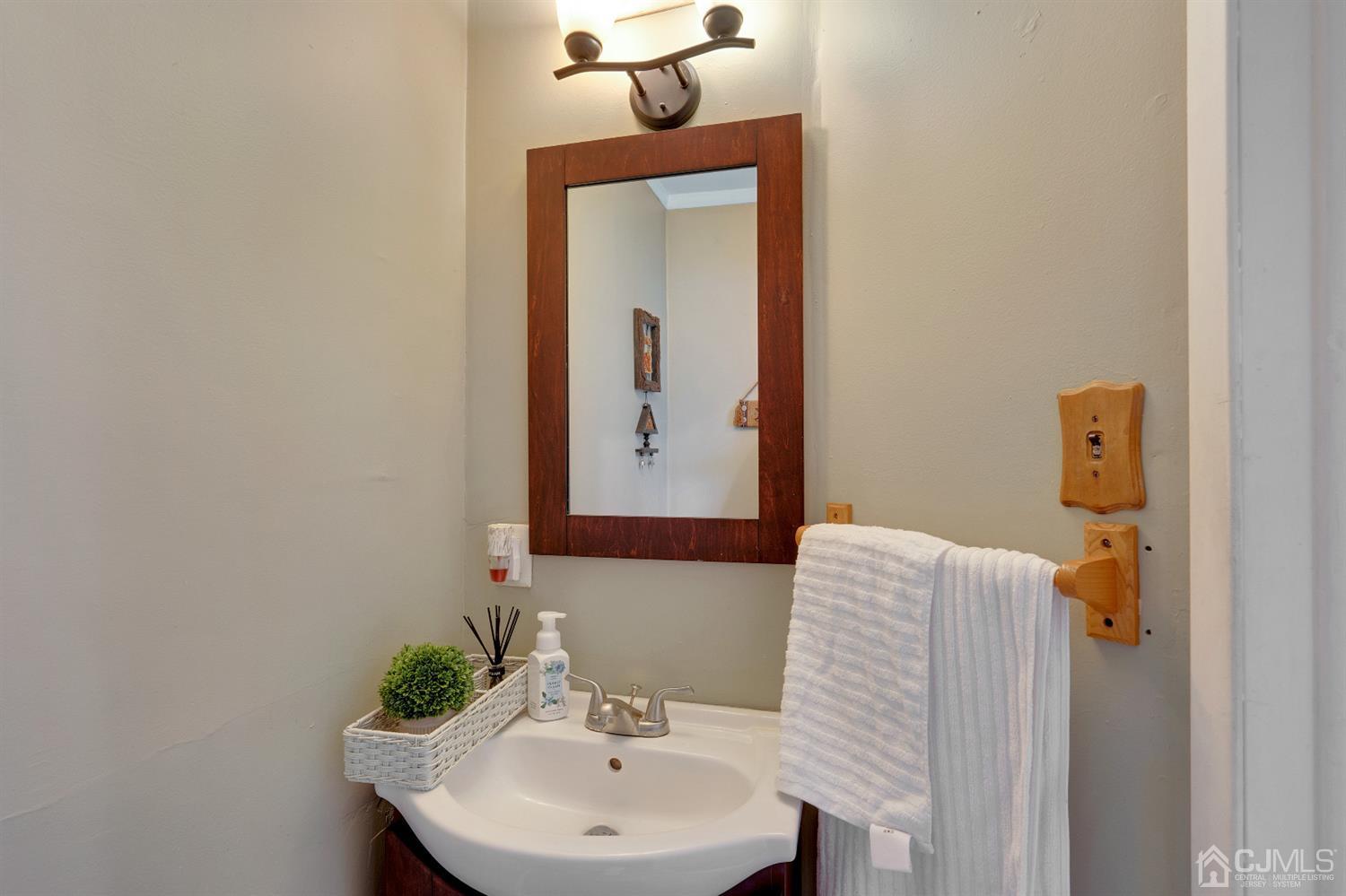 605 Beers Street Hazlet, NJ 07730 - Photo 23 of 32 a bathroom with a sink and a mirror