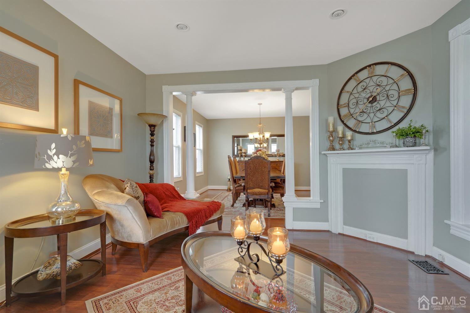 605 Beers Street Hazlet, NJ 07730 - Photo 6 of 32 a living room with furniture a clock and a mirror