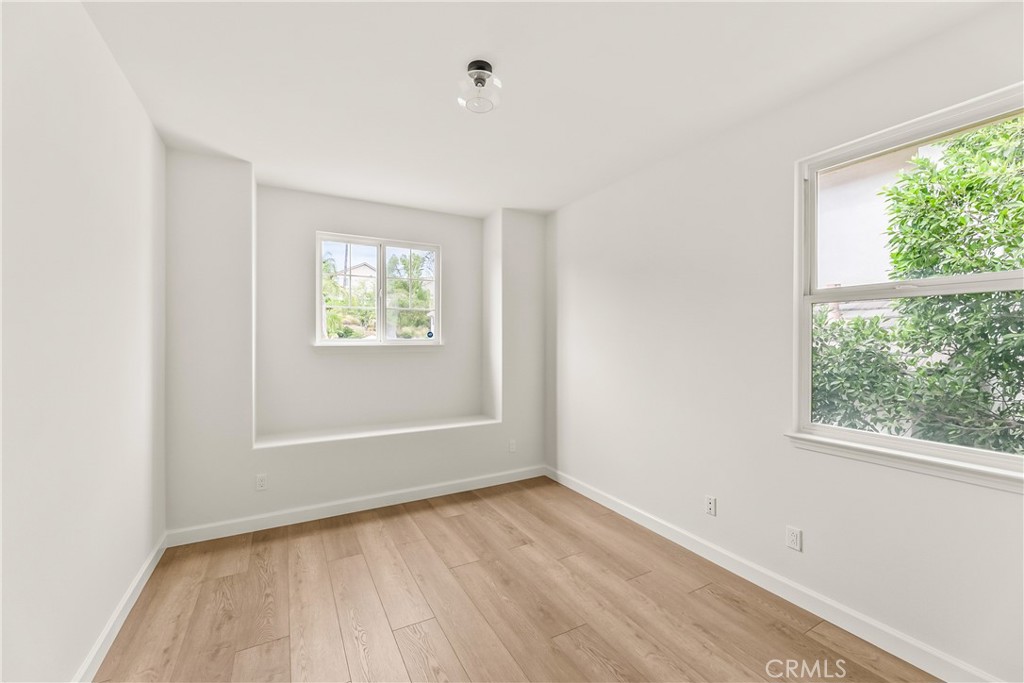 25930 Franklin Lane Stevenson Ranch, CA 91381 - Photo 31 of 47 an empty room with wooden floor and windows