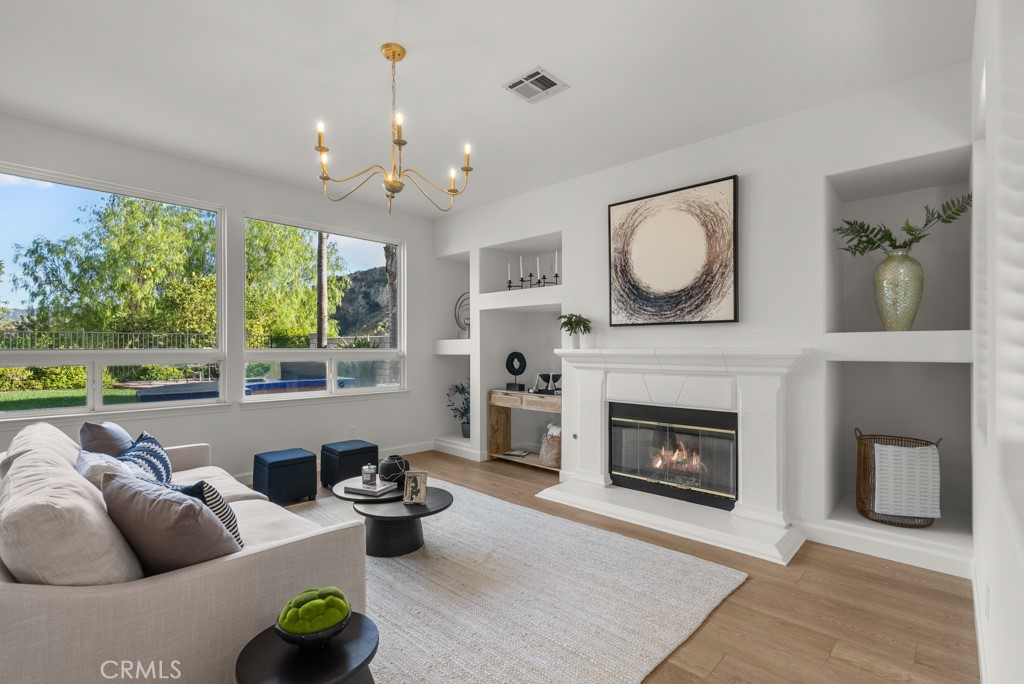 25930 Franklin Lane Stevenson Ranch, CA 91381 - Photo 5 of 47 a living room with furniture a fireplace and a floor to ceiling window