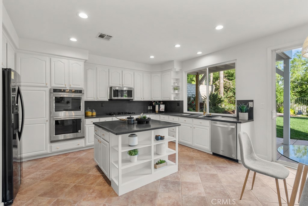 25930 Franklin Lane Stevenson Ranch, CA 91381 - Photo 7 of 47 a kitchen with a stove a refrigerator and a sink