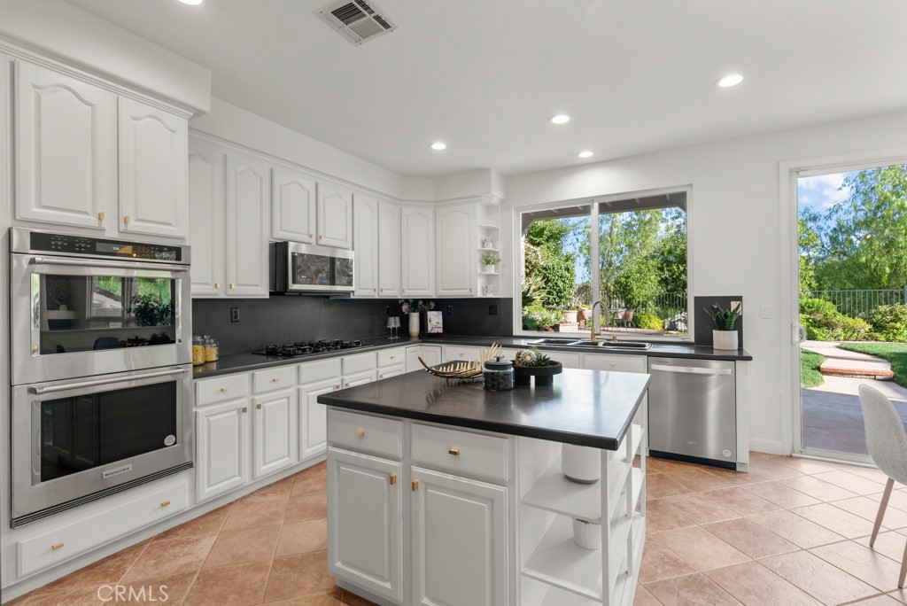 25930 Franklin Lane Stevenson Ranch, CA 91381 - Photo 9 of 47 a kitchen with a sink stove and microwave