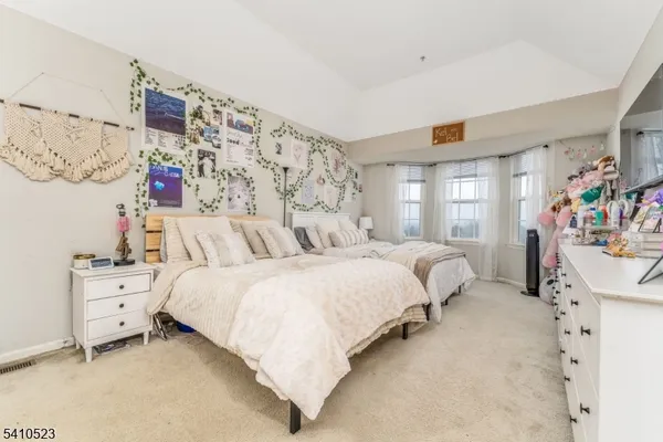 a bedroom with bed and a window