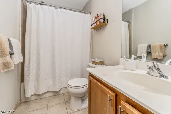 a bathroom with a sink a toilet and shower curtain