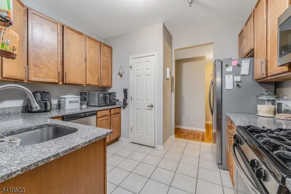 a kitchen that has a sink cabinets and a stove top oven