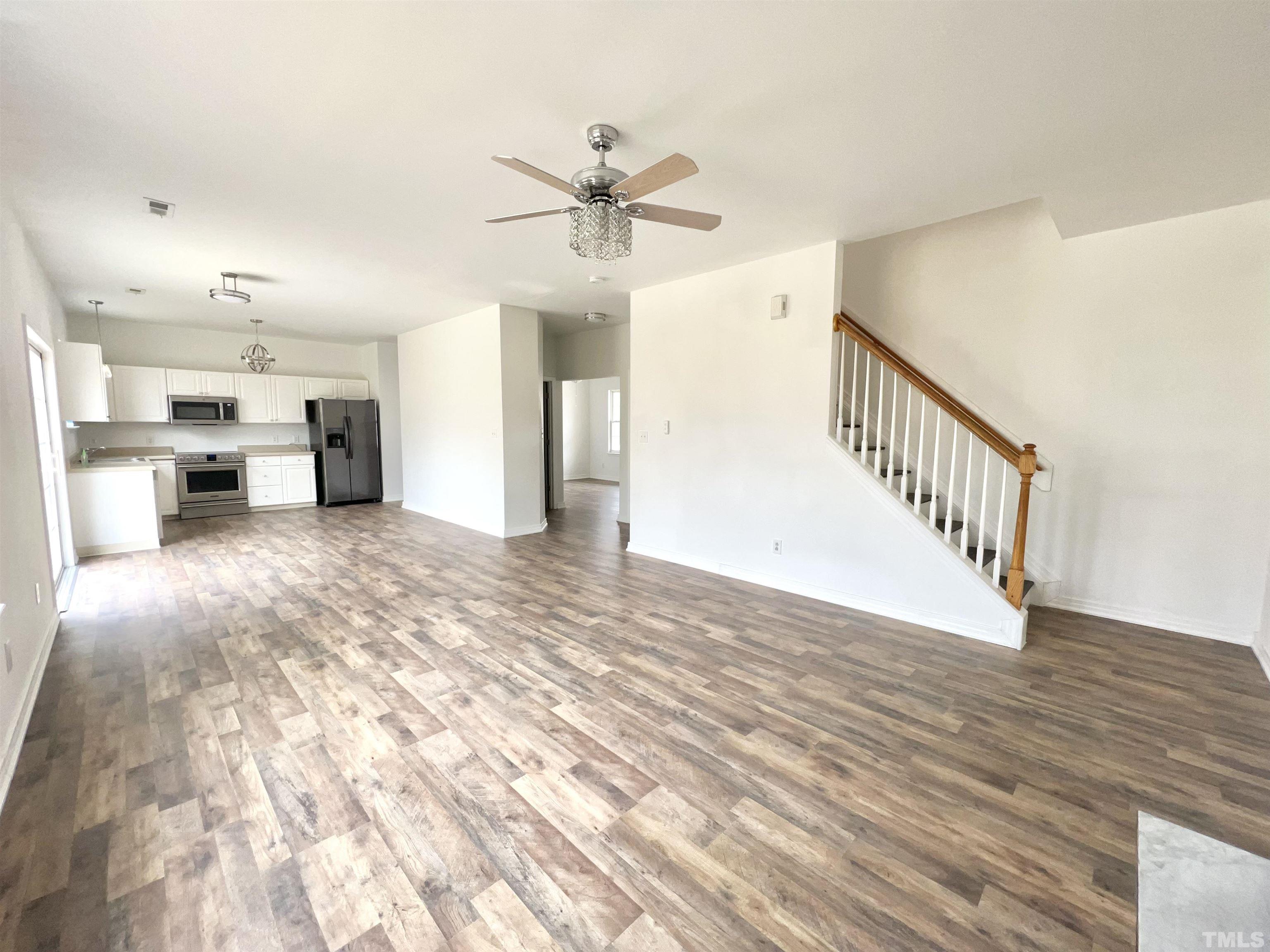 7000 Spanglers Spring Way Raleigh, NC 27610 - Photo 8 of 21 a view of a livingroom with wooden floor and a ceiling fan