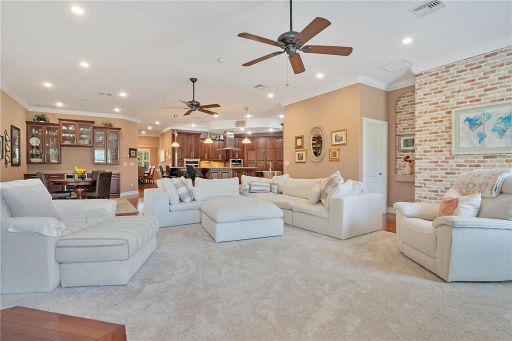 5785 Gilliam Road Orlando, FL 32818 - Photo 33 of 100 a living room with furniture kitchen view and a chandelier
