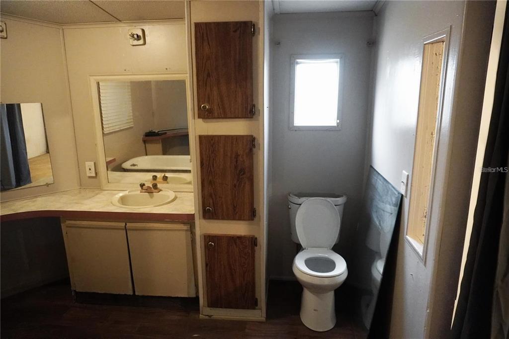 7230 James Stanaland Road Plant City, FL 33567 - Photo 20 of 26 a bathroom with a toilet sink and mirror