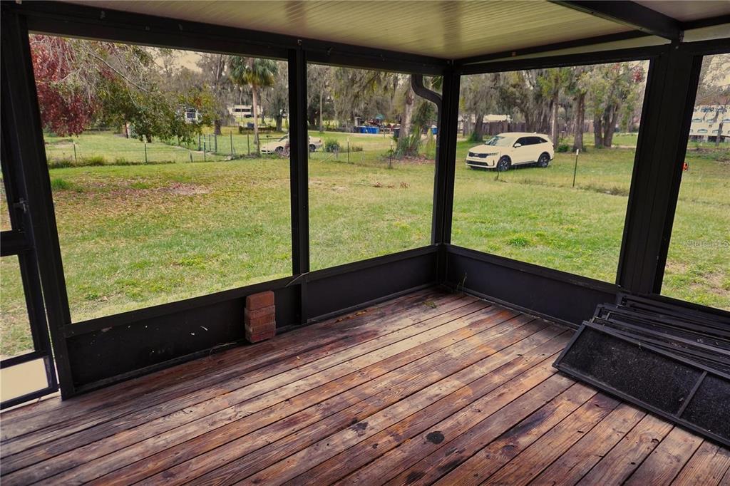 7230 James Stanaland Road Plant City, FL 33567 - Photo 23 of 26 a view of a room with wooden floor and windows