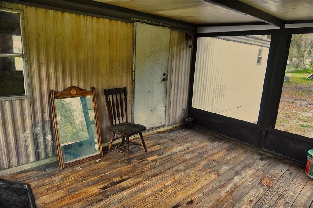 7230 James Stanaland Road Plant City, FL 33567 - Photo 25 of 26 a view of an empty room with wooden floor and a window