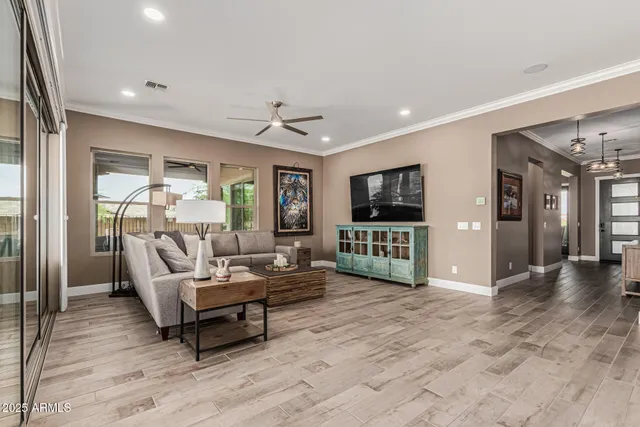 a bedroom with a bed a mirror on dresser and a window