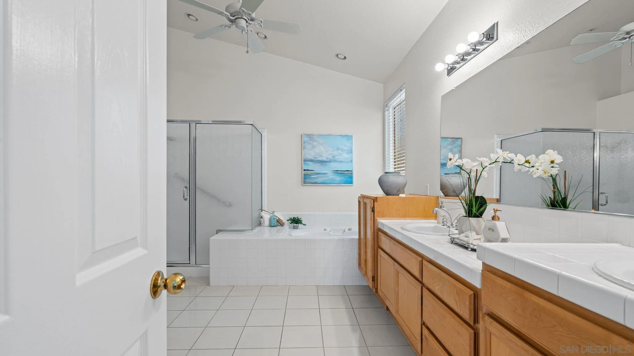 1783 Medinah Road San Marcos, CA 92069 - Photo 19 of 39 a bathroom with a double vanity sink mirror and bathtub