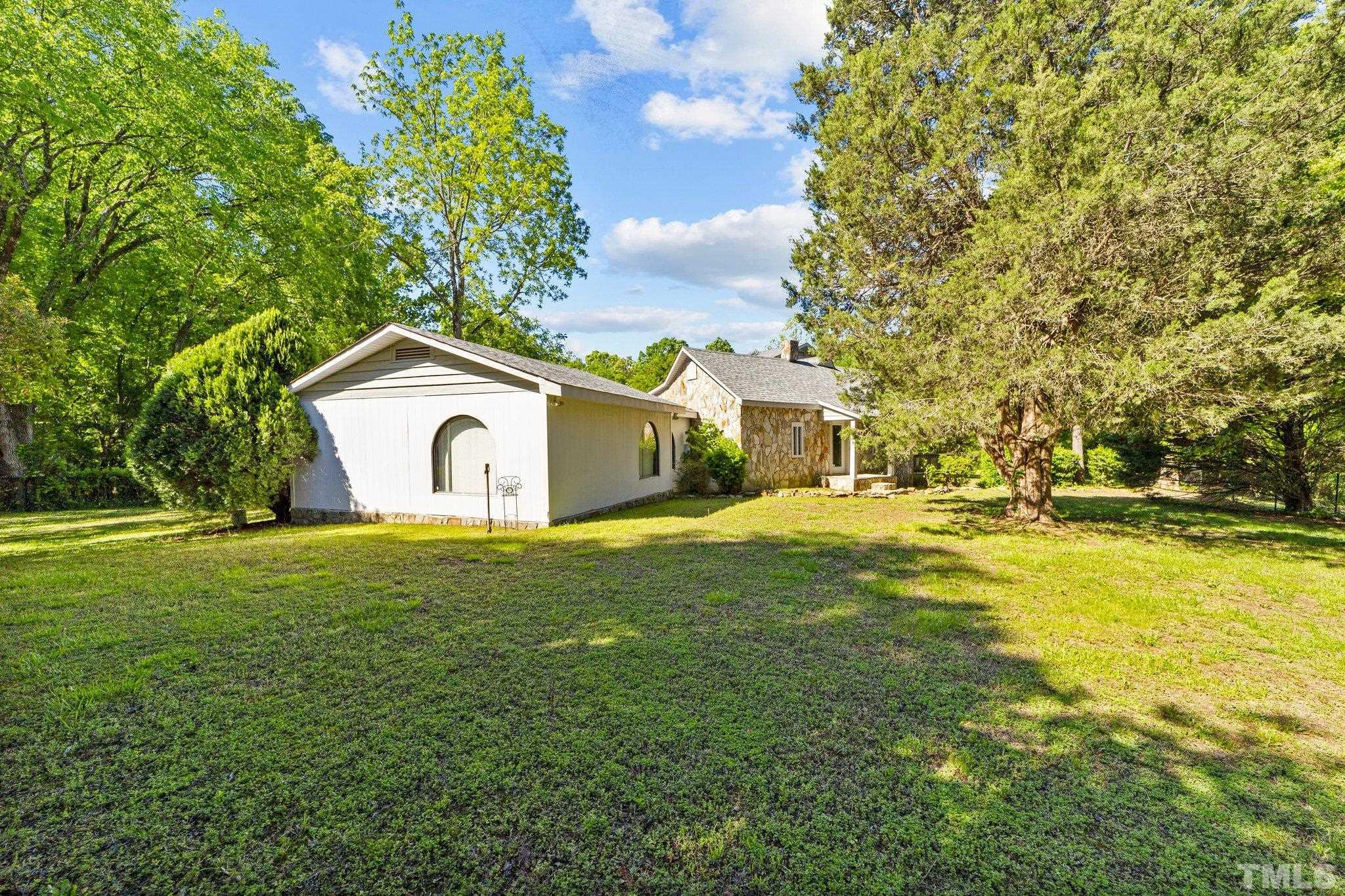 225 Huff Garrett Road Roxboro, NC 27574 - Photo 27 of 38 a front view of a house with a garden